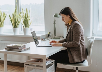 A woman in professional business attire concentrates on her work A woman in professional business attire concentrates on her work